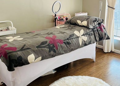 Tranquil spa treatment room at Make Me Pretti‎, Cape Town, Western Cape, ZA with floral bedding.