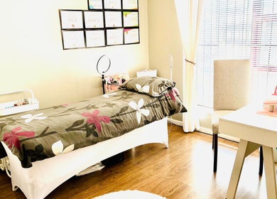 Make Me Pretti‎ beauty room in Cape Town, Western Cape, ZA with floral bedspread and bright sunlight.