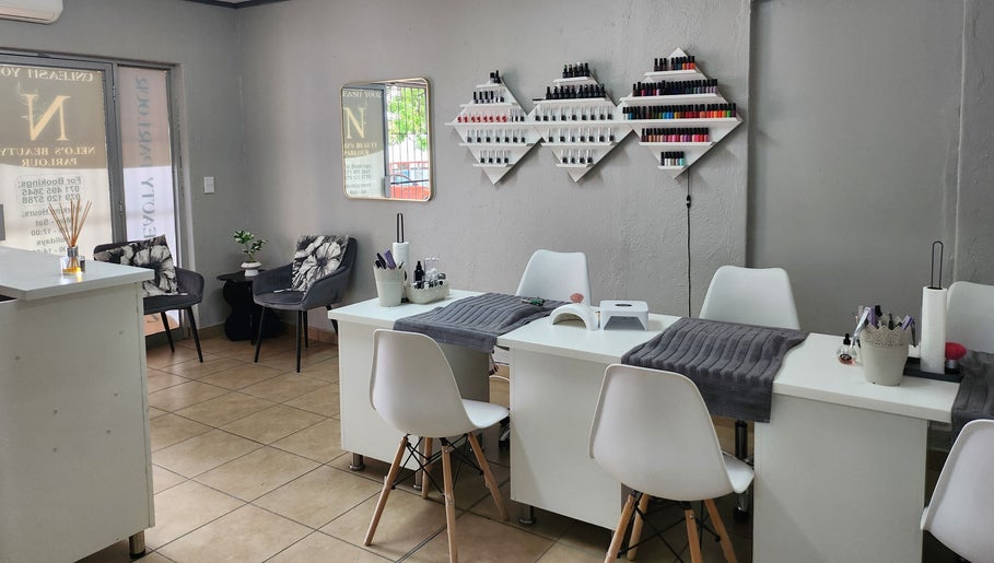Nelos Beauty Parlour, Mbombela, Mpumalanga, ZA interior with manicure stations and polish display.