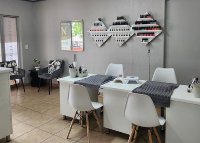 Nelos Beauty Parlour, Mbombela, Mpumalanga, ZA interior with manicure stations and polish display.