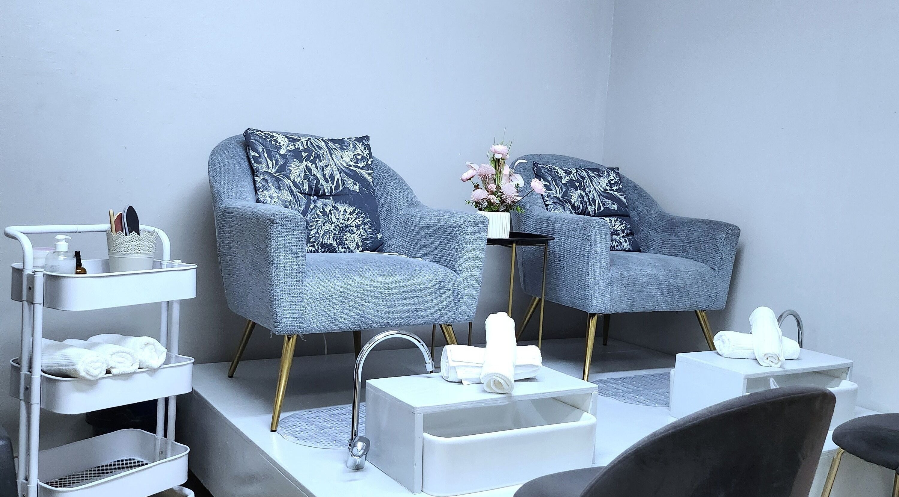 Relaxing pedicure chairs at Nelos Beauty Parlour, Mbombela, Mpumalanga, ZA with floral decor and soft towels.