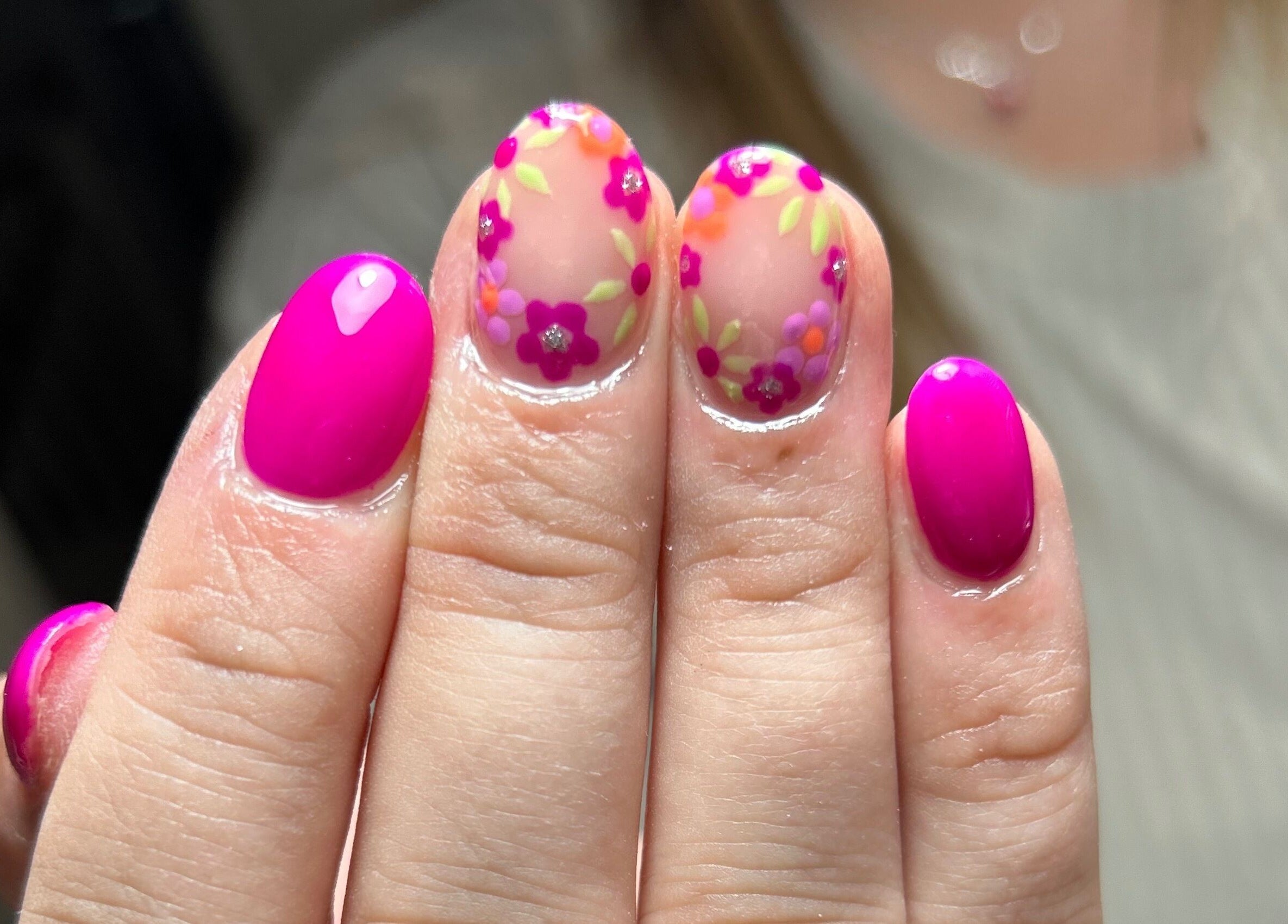 Vibrant floral nail art at Nails By Lara in Nottingham, England, GB featuring fuchsia and floral designs.