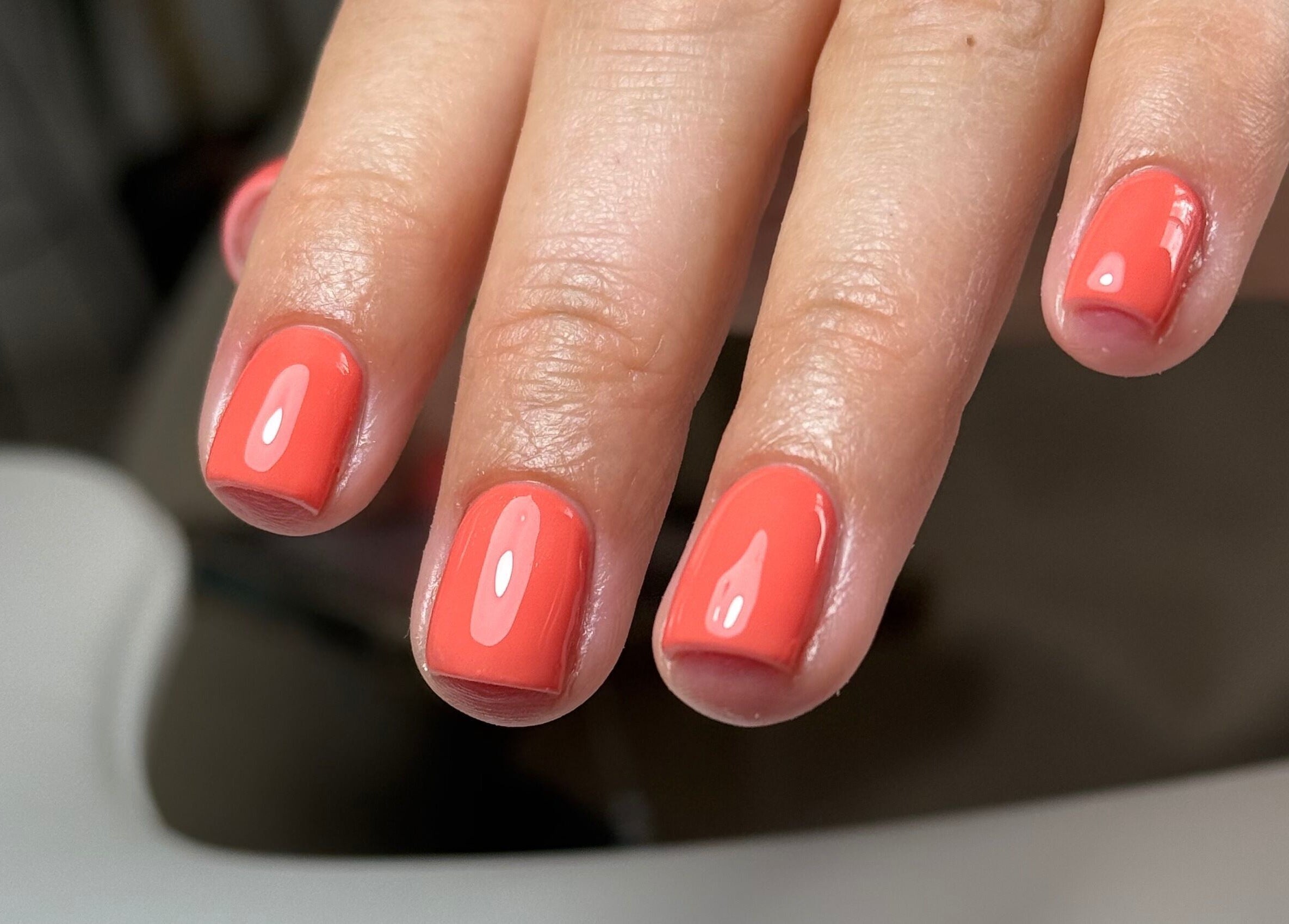 Bright coral nails at Nails By Lara, Nottingham, England, GB, showcasing expert manicure services.