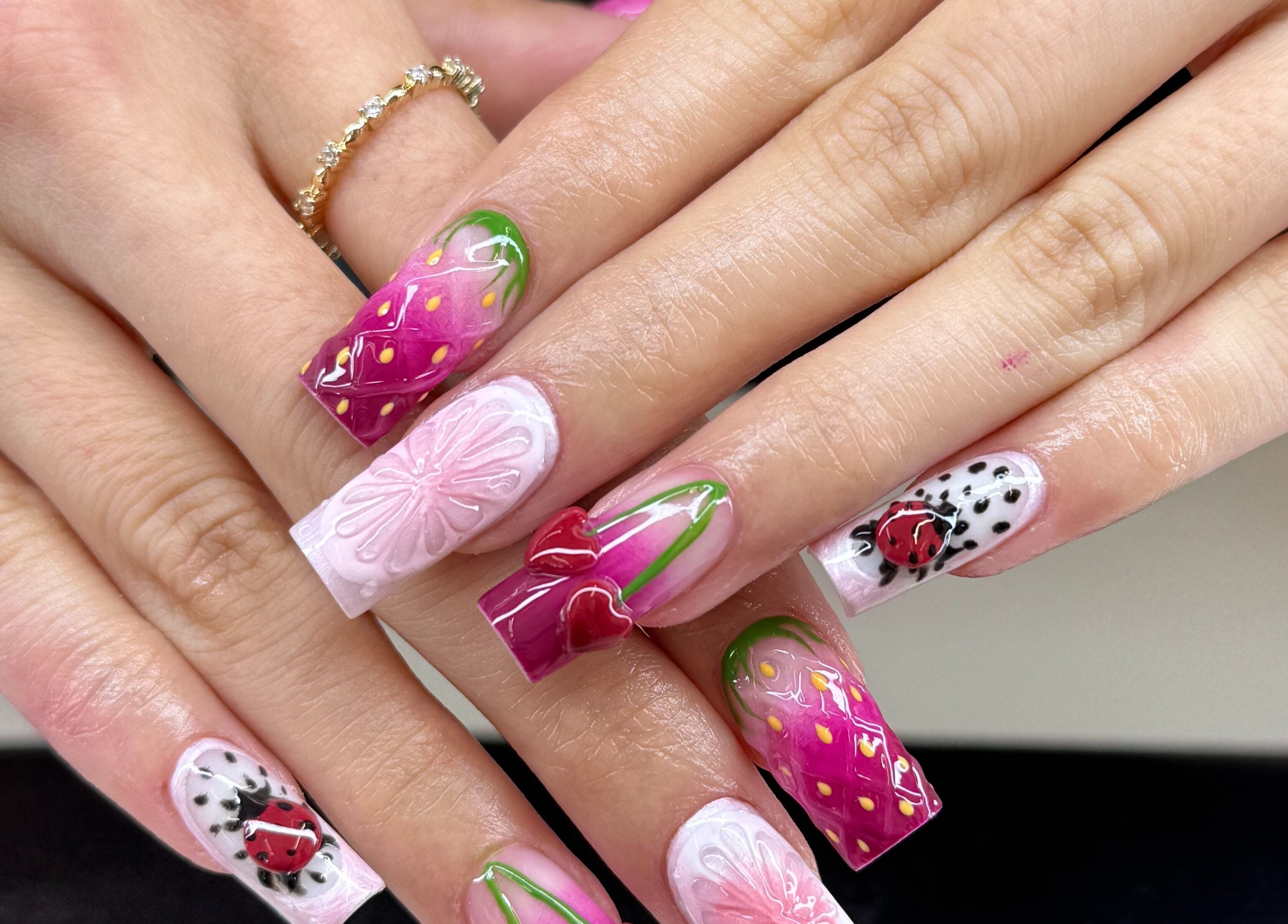 Intricate nail art with flowers and ladybug design at Icon Nails & Beauty, Zürich, Zürich, CH.