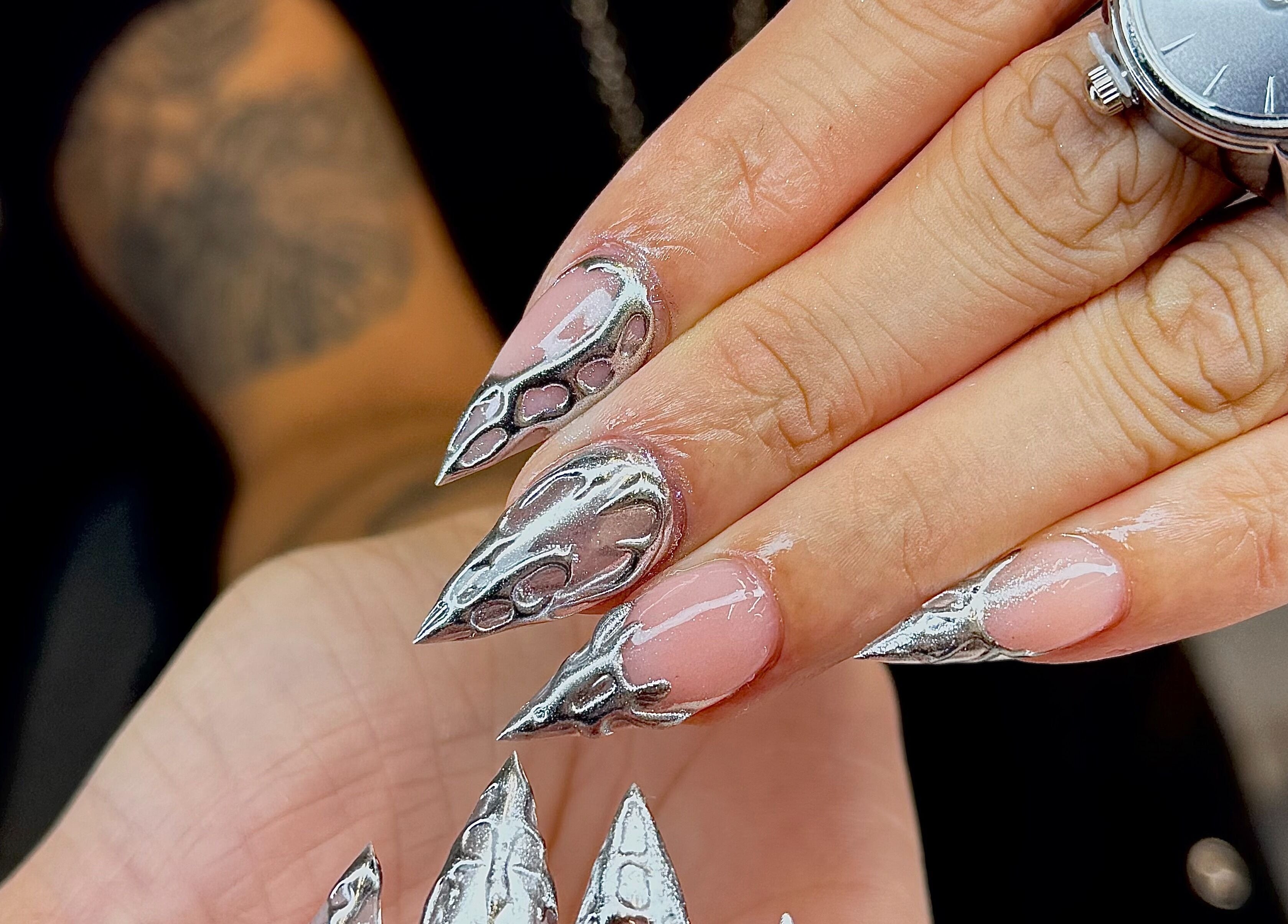 Metallic nail art at Icon Nails & Beauty, Zürich, Zürich, CH showcasing intricate, sharp design.