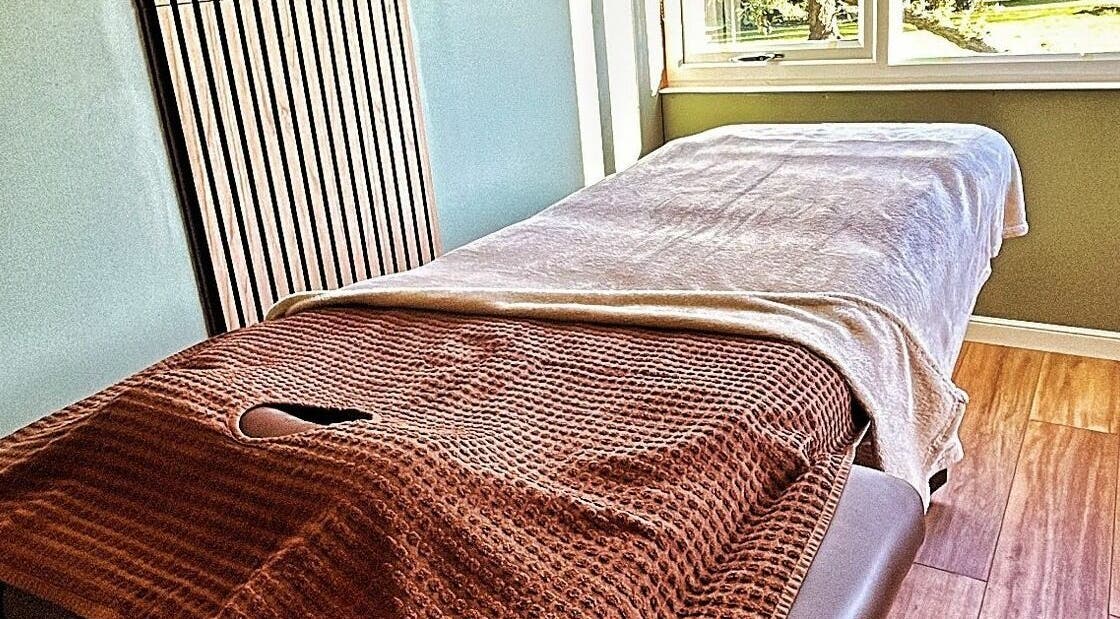 Cozy massage table at The Cabin, Cossall, England, GB, bathed in natural light.
