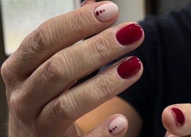 Detailed nail art with red polish at Irysha.beauty, Chichester, England, GB, showcasing expert manicure.