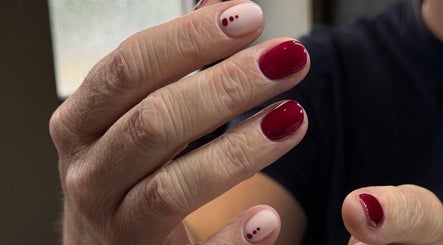 Detailed nail art with red polish at Irysha.beauty, Chichester, England, GB, showcasing expert manicure.