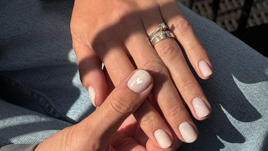 Elegant nail art with white heart design at Irysha.beauty in Chichester, England, GB.