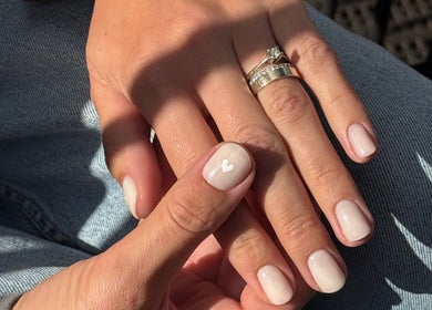 Elegant nail art with white heart design at Irysha.beauty in Chichester, England, GB.