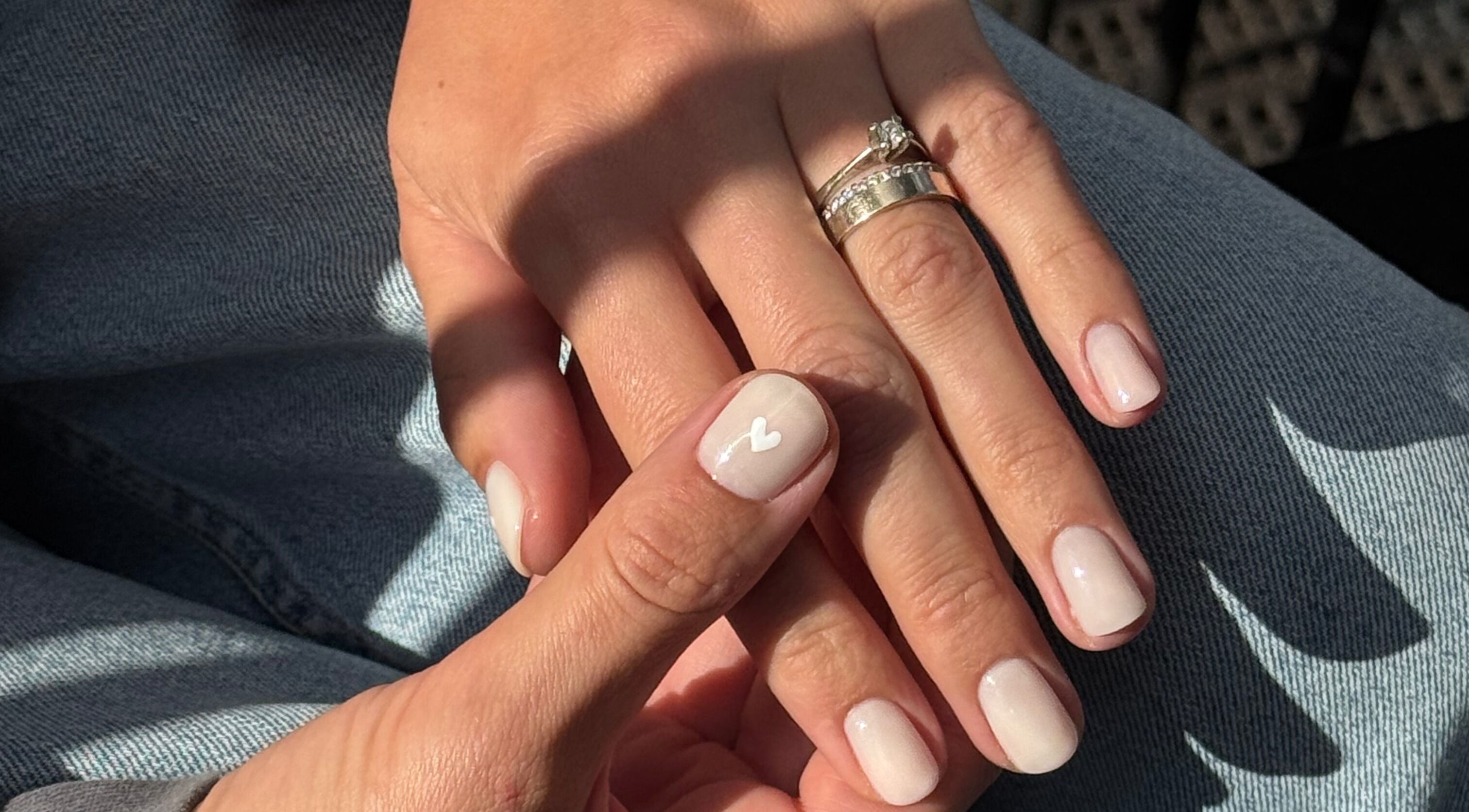 Elegant nail art with white heart design at Irysha.beauty in Chichester, England, GB.