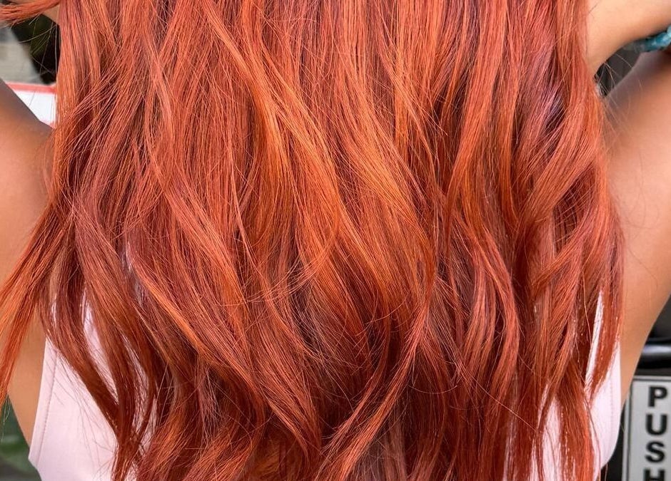 Vibrant red hair styled at BrighTouch, New York, New York, US. Perfect for a bold, fresh look.