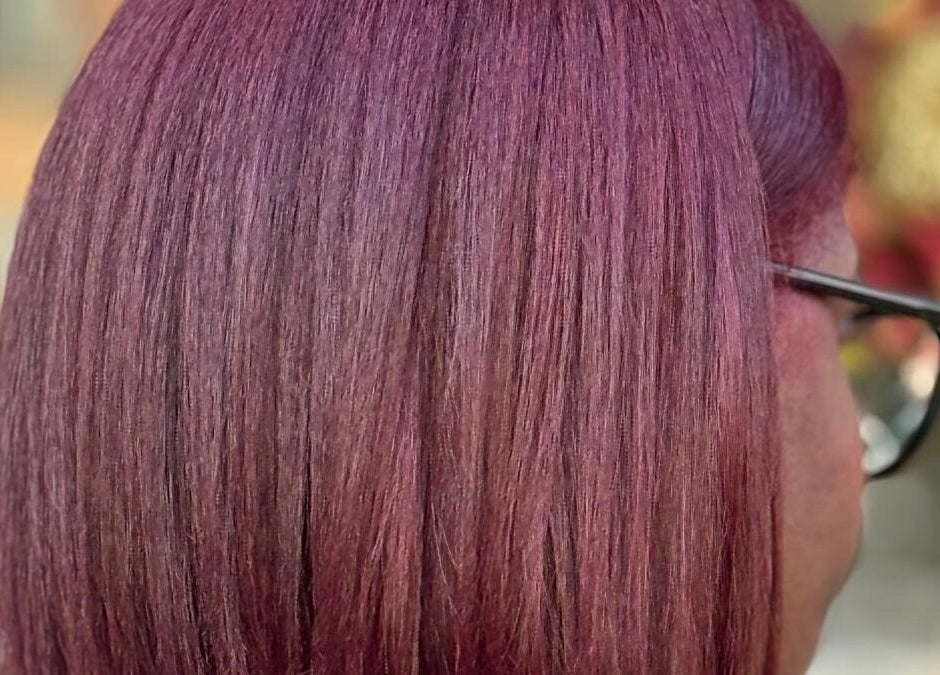 Rich plum hair color on a person's hair at BrighTouch, New York, New York, US.