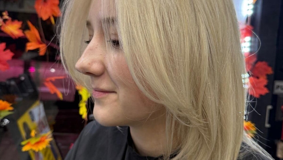 Blonde hair styling at BrighTouch, New York, New York, US with fall leaf decor.