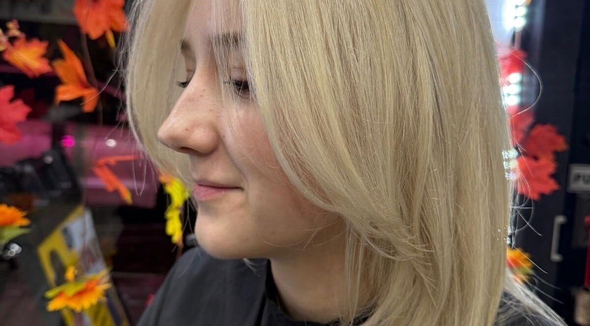 Blonde hair styling at BrighTouch, New York, New York, US with fall leaf decor.