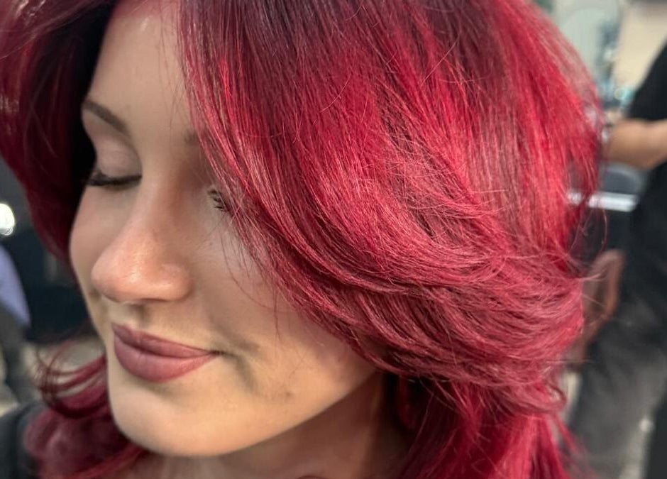 Vibrant red hair styled at BrighTouch salon in New York, New York, US, showcasing expert coloring techniques.