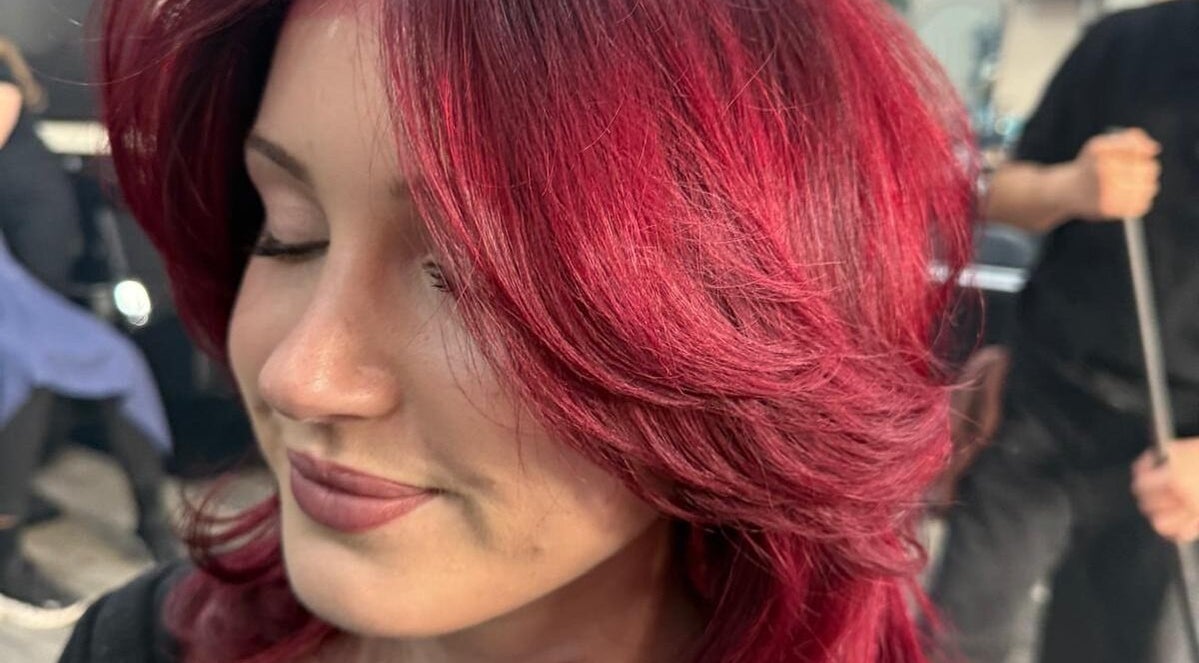 Vibrant red hair styled at BrighTouch salon in New York, New York, US, showcasing expert coloring techniques.