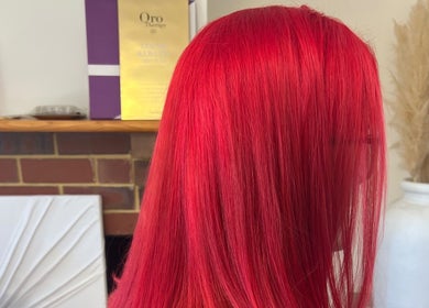Vibrant red hair styled at Haus of Hair & Beauty, The Vines, Western Australia, AU, showcasing salon quality.