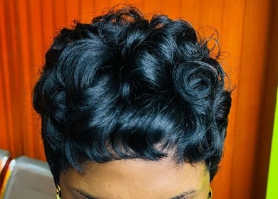 Stylish curled hairstyle at Edge Allure Beauty, Kingston, St. Andrew Parish, JM, showcasing vibrant design.