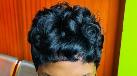 Stylish curled hairstyle at Edge Allure Beauty, Kingston, St. Andrew Parish, JM, showcasing vibrant design.