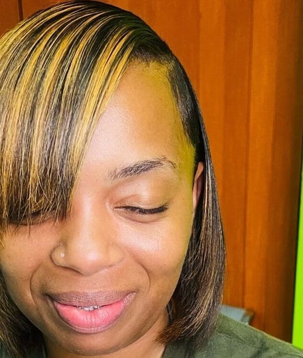 Woman with a sleek hairstyle at Edge Allure Beauty, Kingston, St. Andrew Parish, JM.