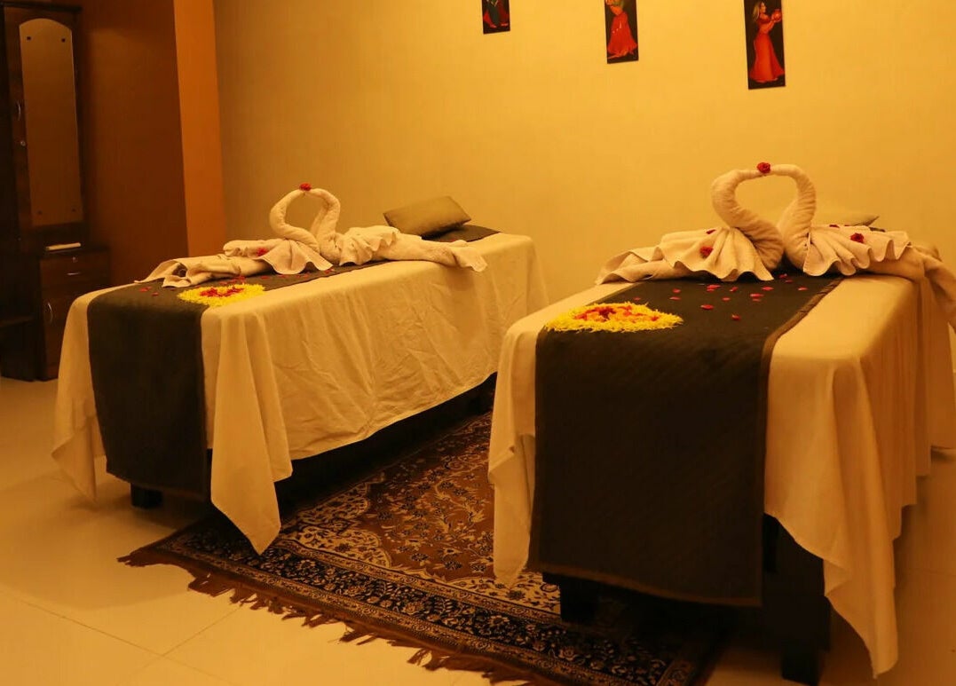 Elegant massage room at Dhara Spa - HSR Layout in Bengaluru, Karnataka, IN with two decorated tables.