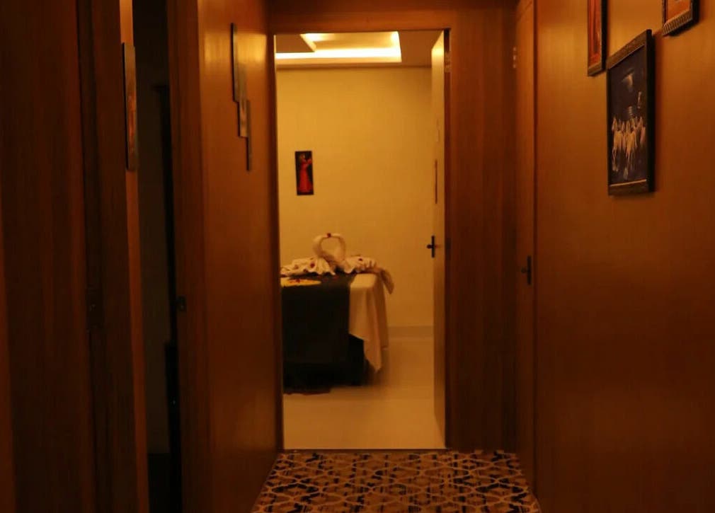 Dimly lit hallway at Dhara Spa - HSR Layout in Bengaluru, Karnataka, IN, leading to a serene massage room.