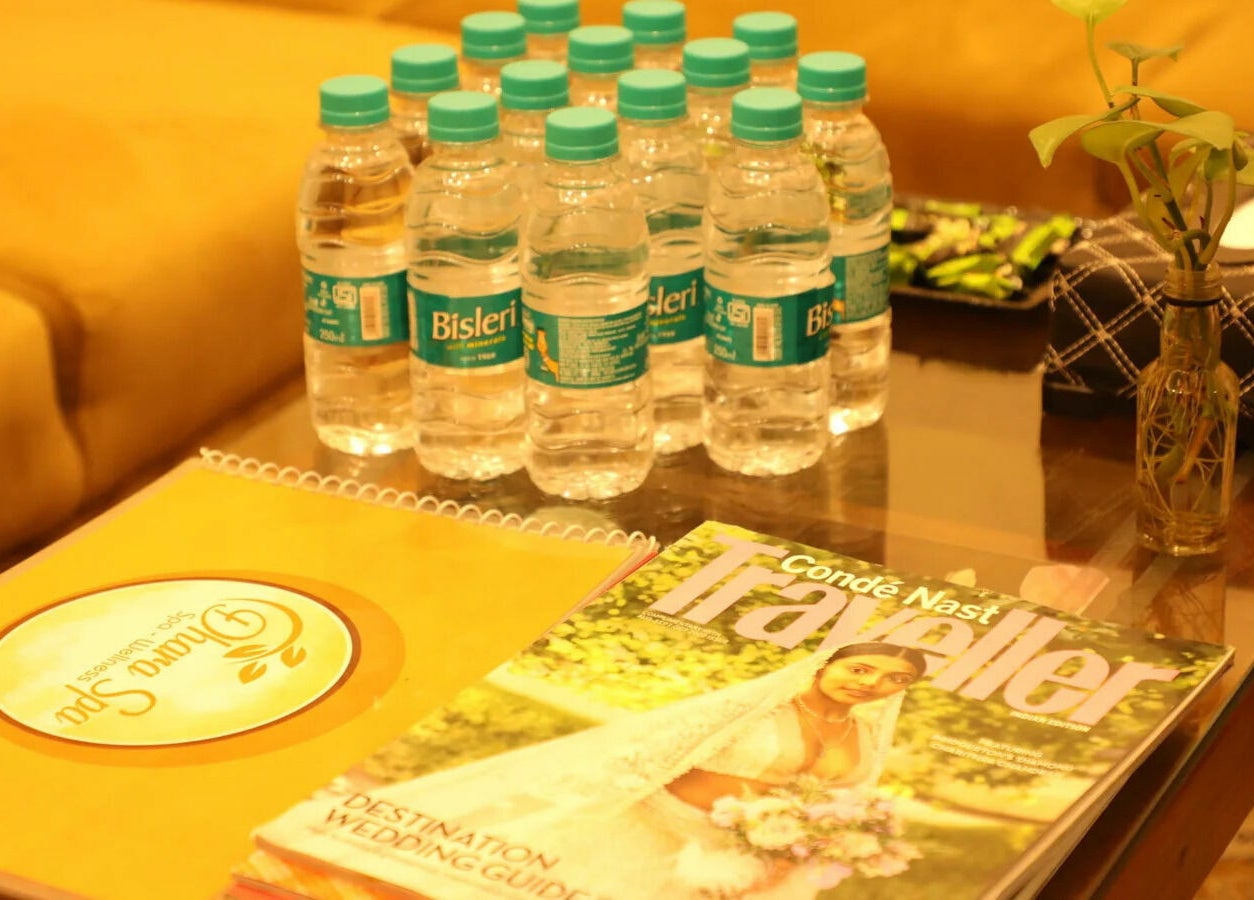 Relaxing waiting area with water and magazines at Dhara Spa - HSR Layout in Bengaluru, Karnataka, IN.