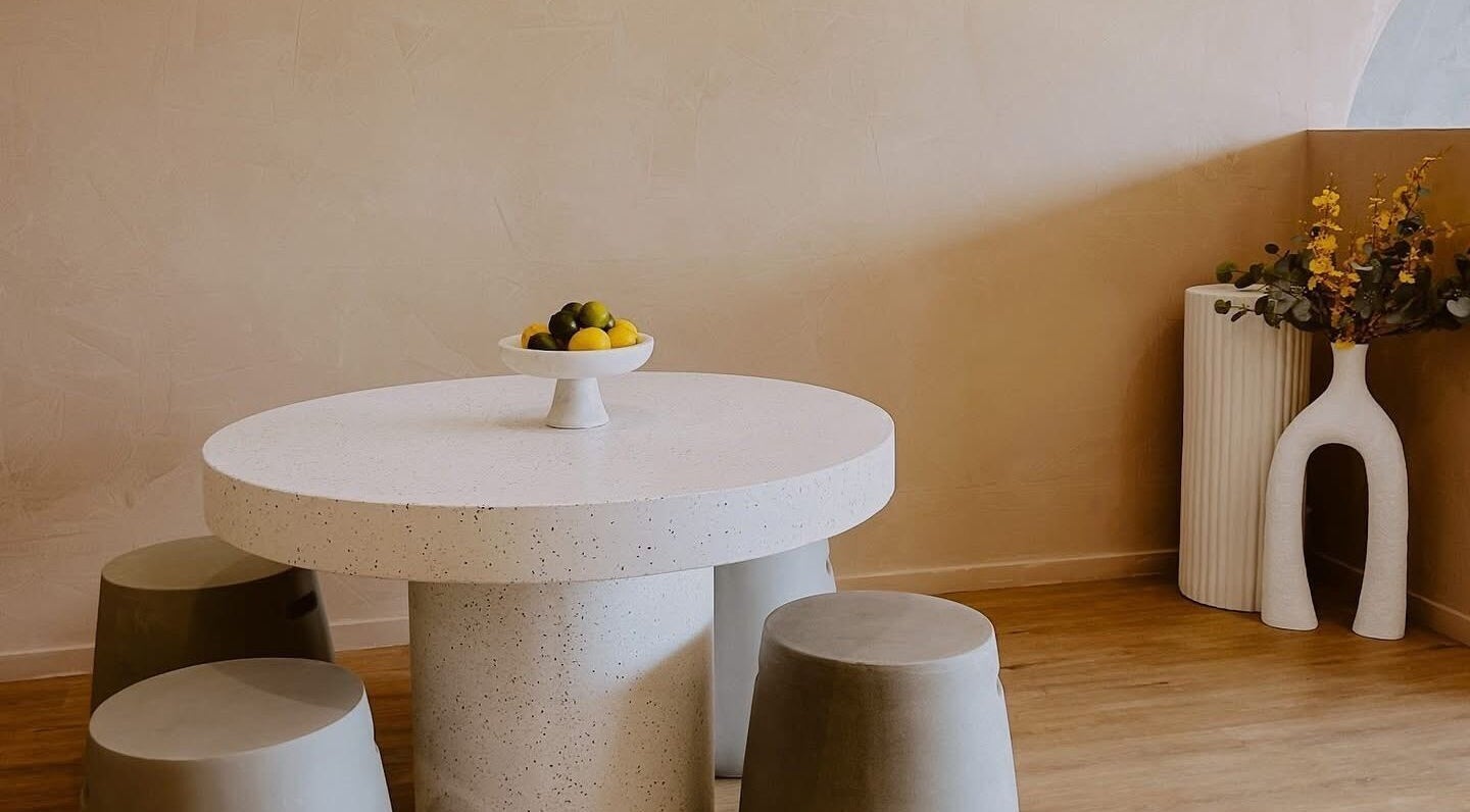 Elegant seating area with round table at Beyond Beauty & Brows Au, Hope Island, Queensland, AU.