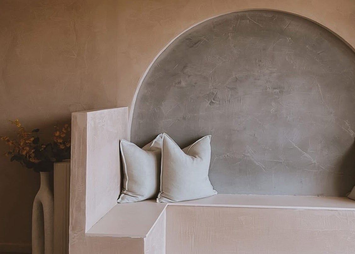 Cozy seating nook at Beyond Beauty & Brows Au, Hope Island, Queensland. A tranquil space with pillows and soft hues.