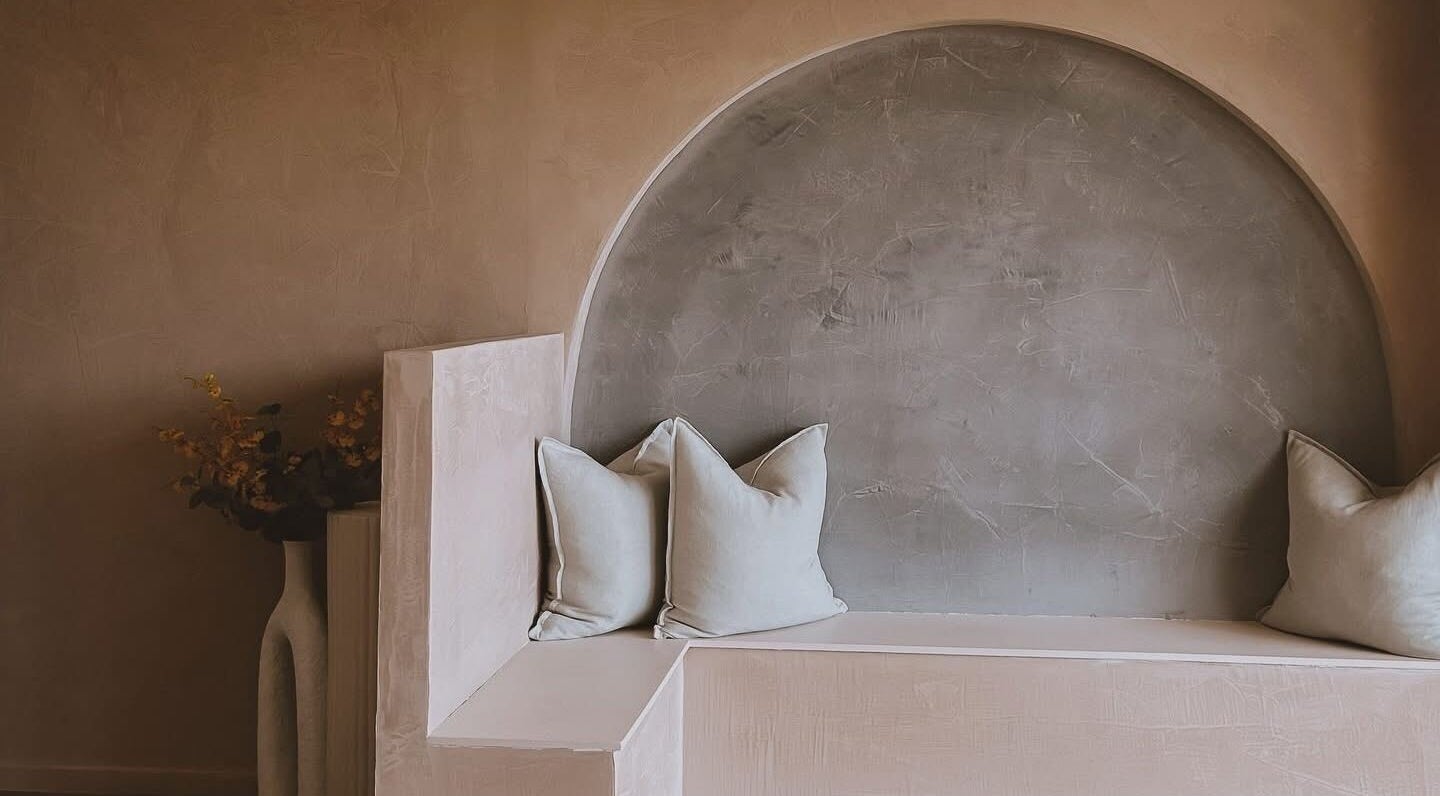 Cozy seating nook at Beyond Beauty & Brows Au, Hope Island, Queensland. A tranquil space with pillows and soft hues.