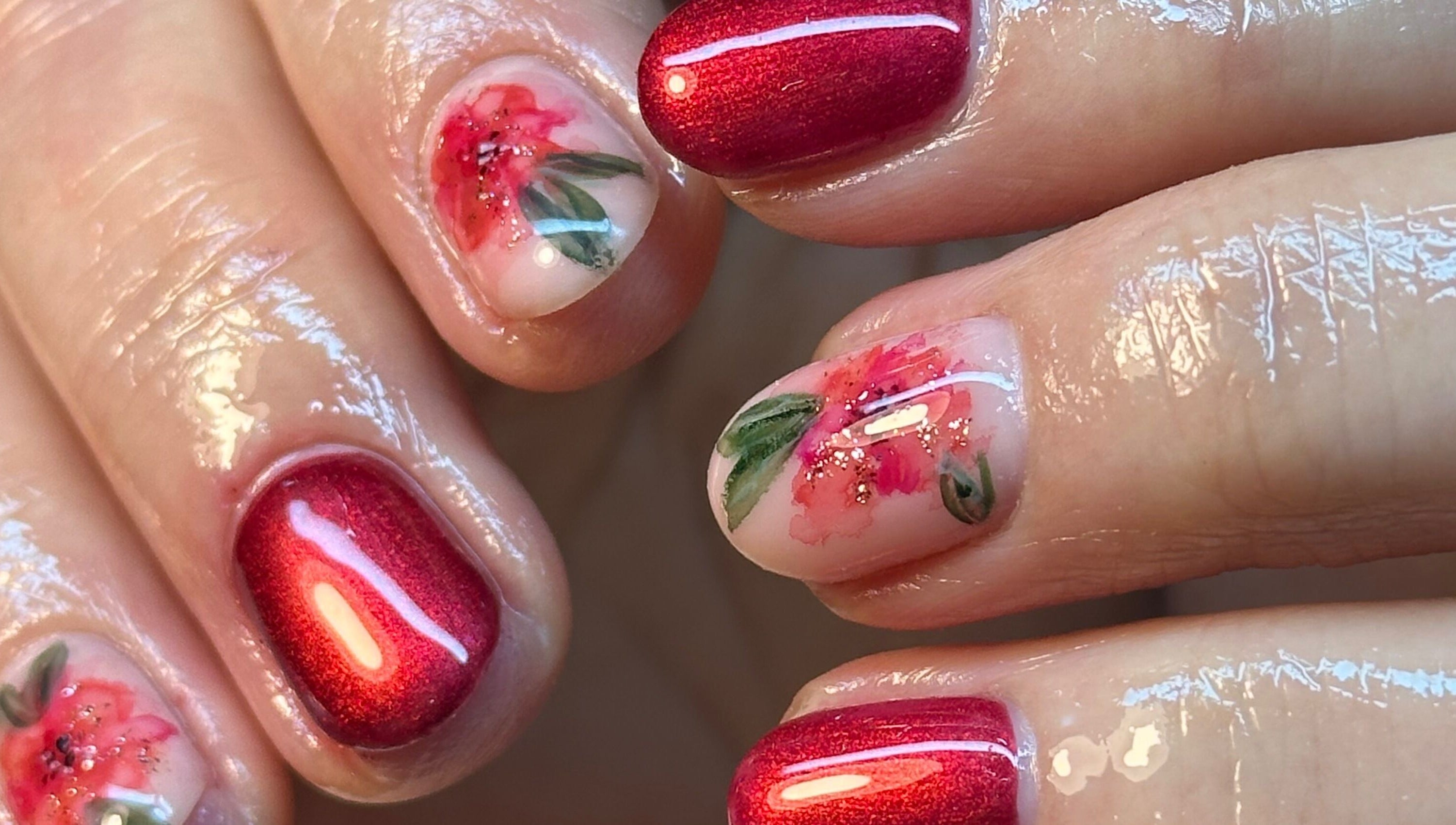 Intricate floral nail art with red polish at BEAUTIMAX, Stockport, England, GB.