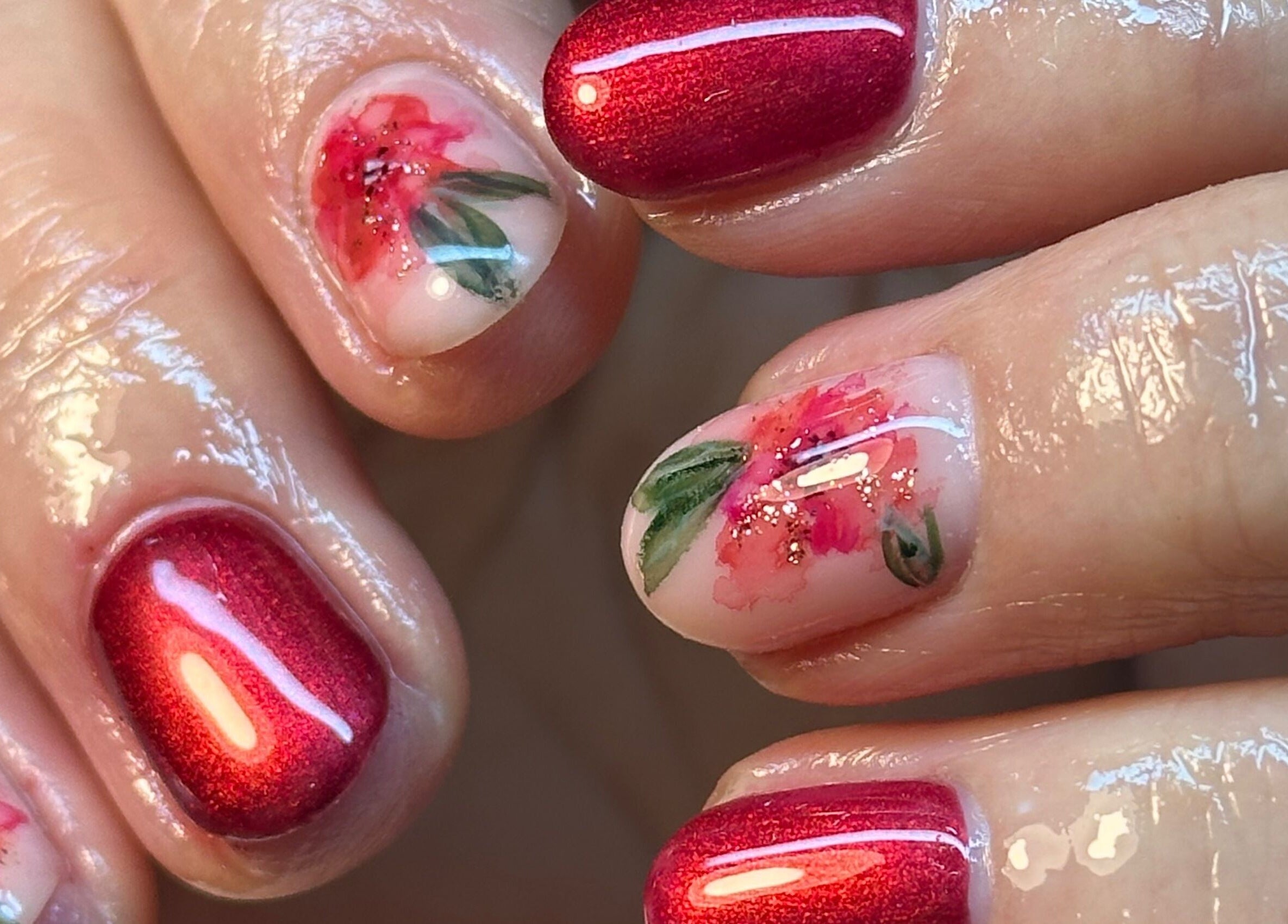 Intricate floral nail art with red polish at BEAUTIMAX, Stockport, England, GB.