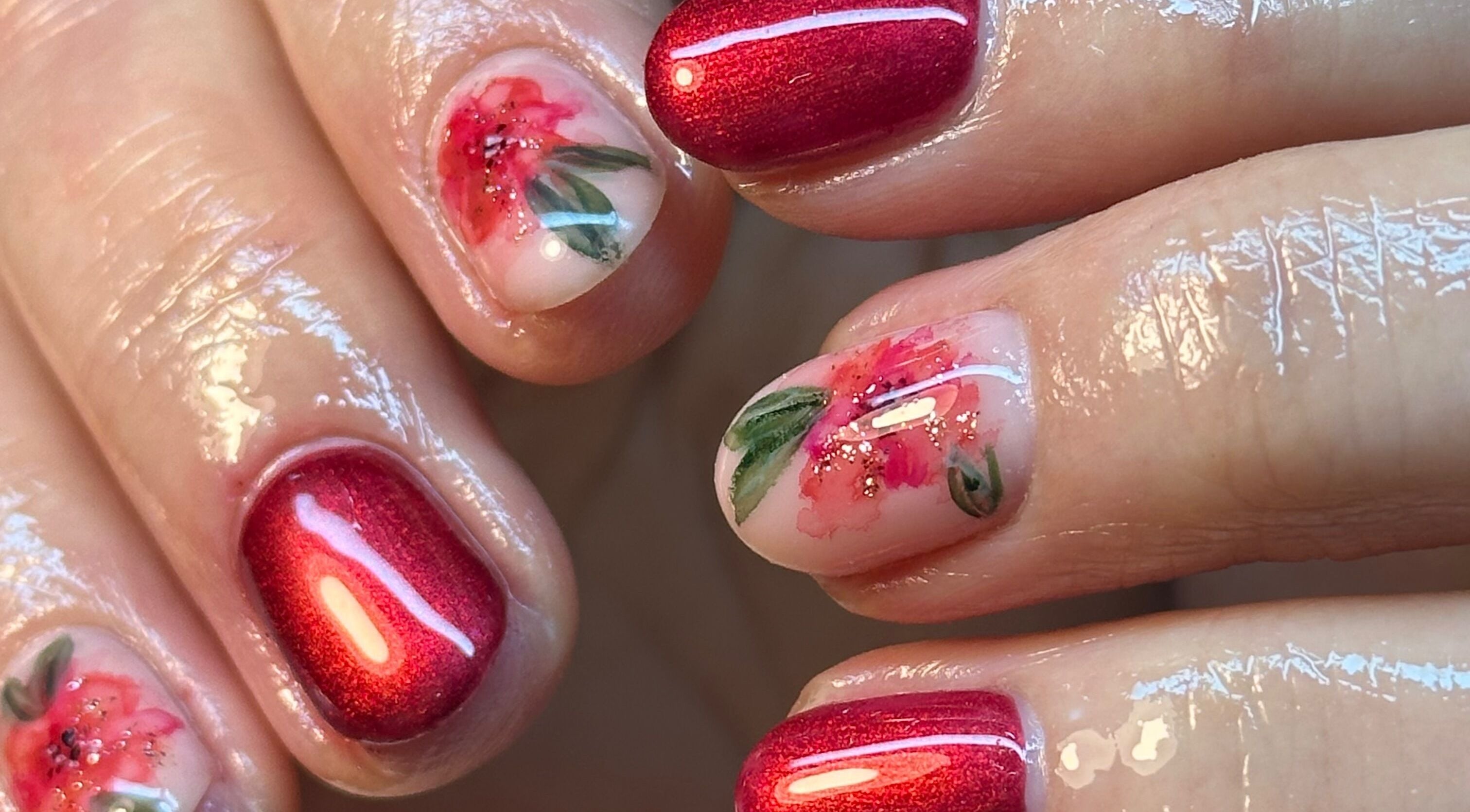 Intricate floral nail art with red polish at BEAUTIMAX, Stockport, England, GB.