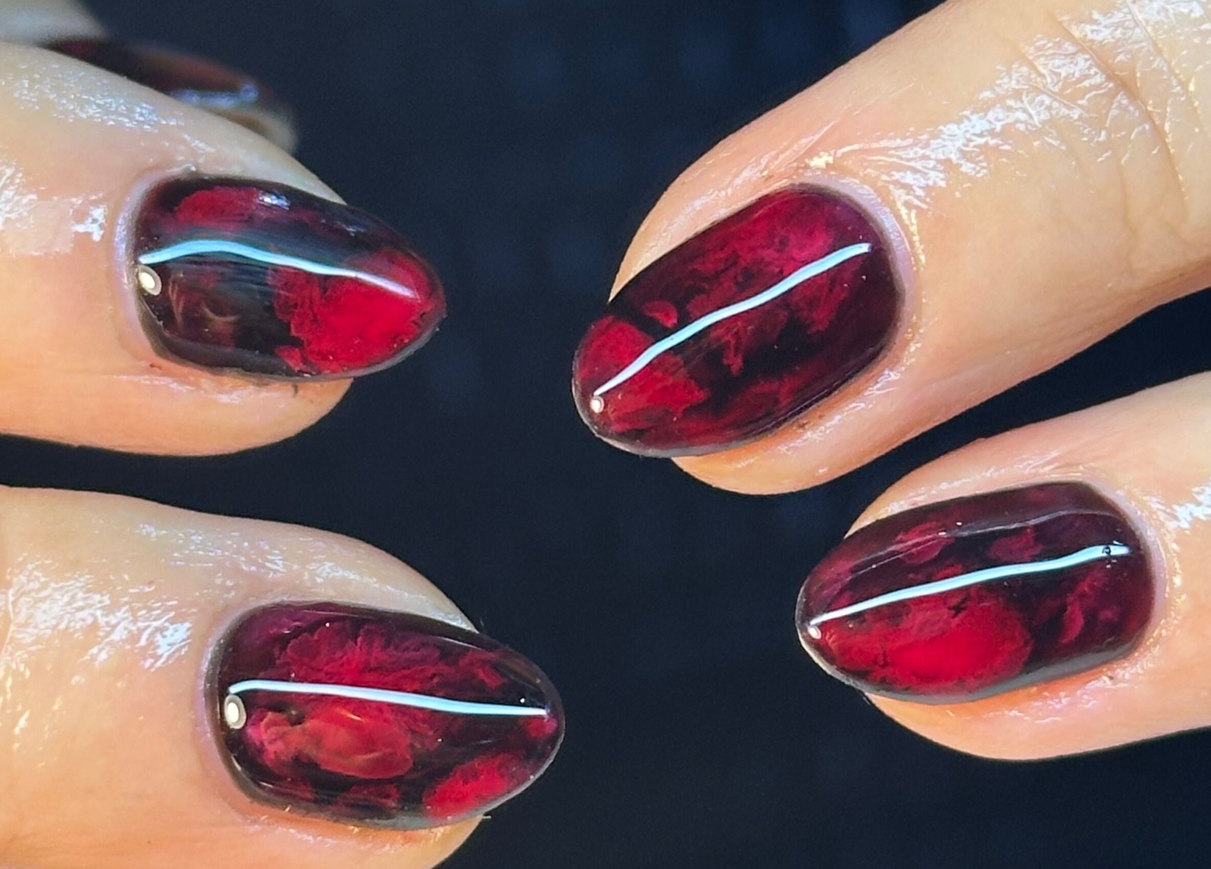 Elegant red gel nails at BEAUTIMAX, Stockport, England, GB showcase exquisite nail artistry.