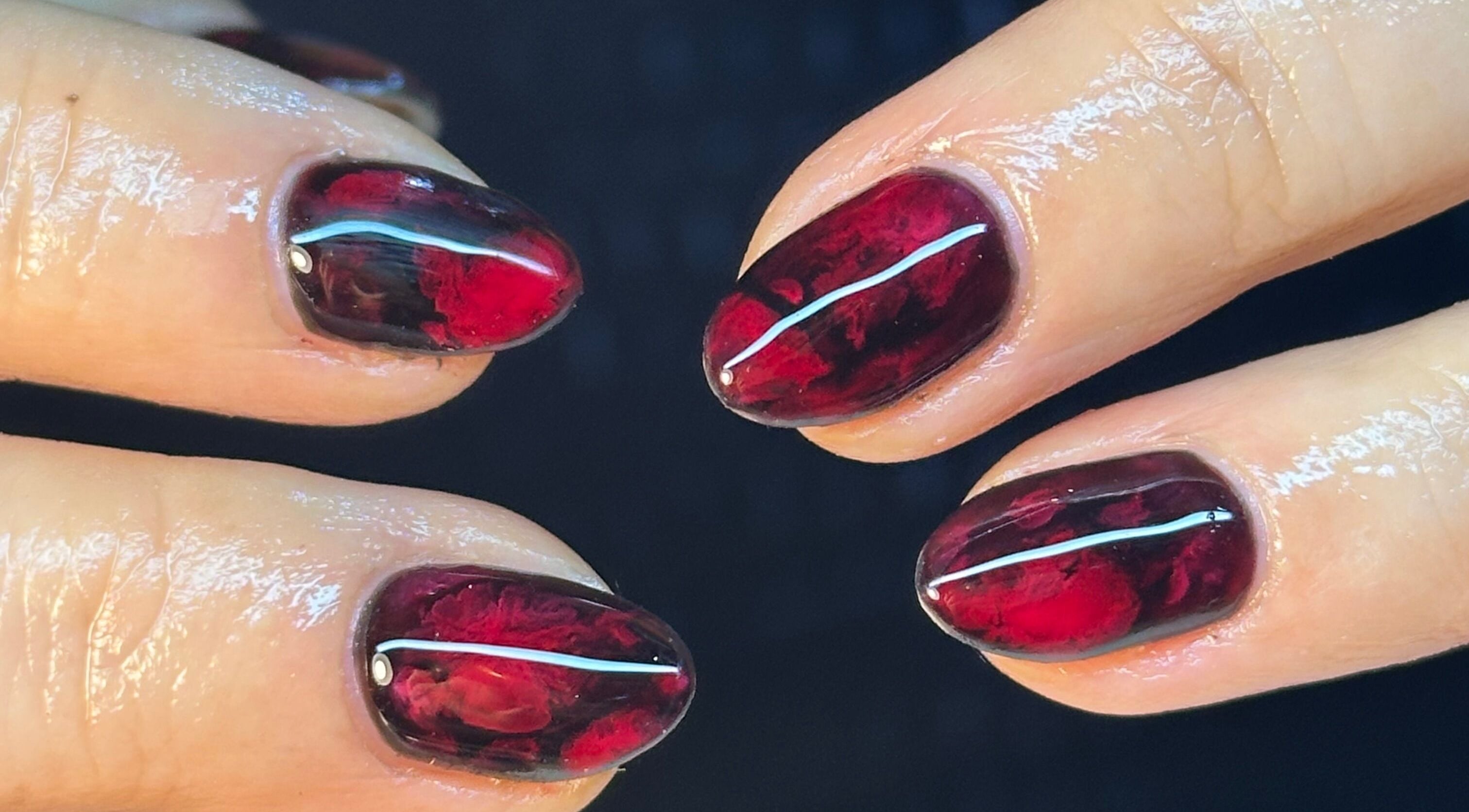 Elegant red gel nails at BEAUTIMAX, Stockport, England, GB showcase exquisite nail artistry.