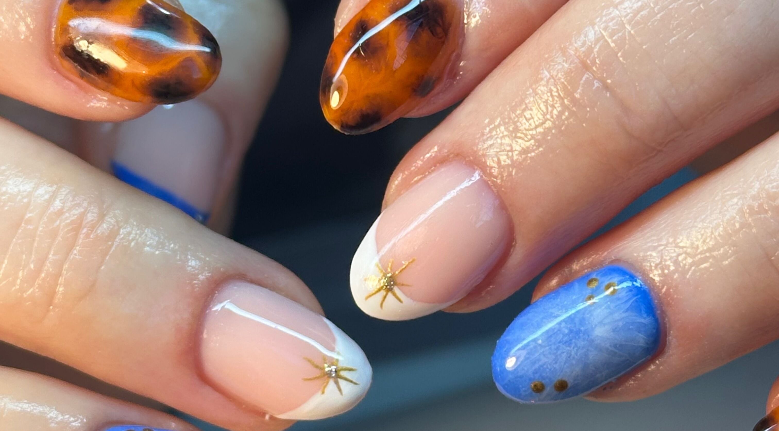Artistic nail designs at BEAUTIMAX in Stockport, England, GB showcasing unique patterns and vibrant colors.