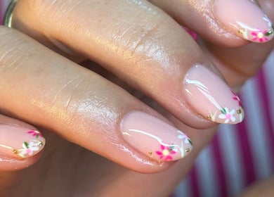 Delicate floral nail art at BEAUTIMAX, Stockport, England, GB, showcasing intricate pink and white designs.