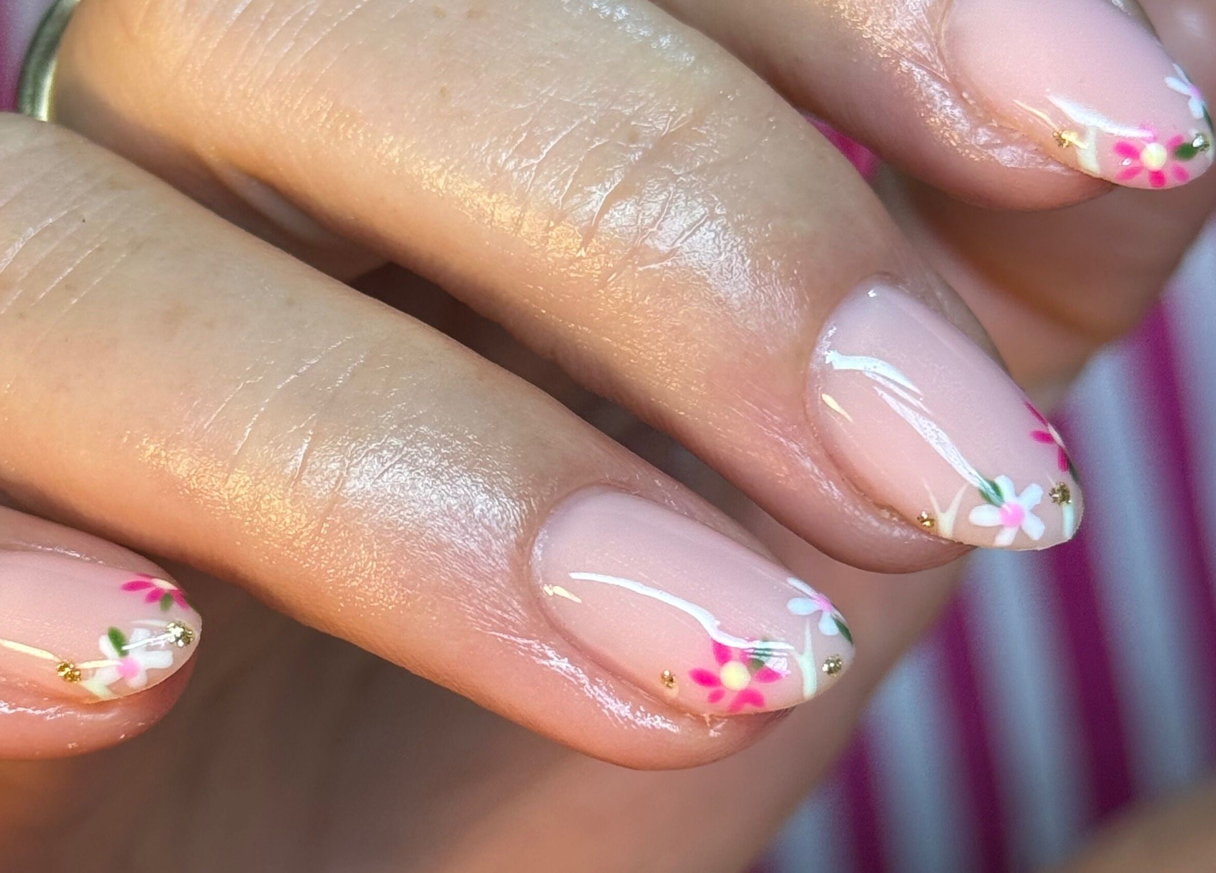 Delicate floral nail art at BEAUTIMAX, Stockport, England, GB, showcasing intricate pink and white designs.