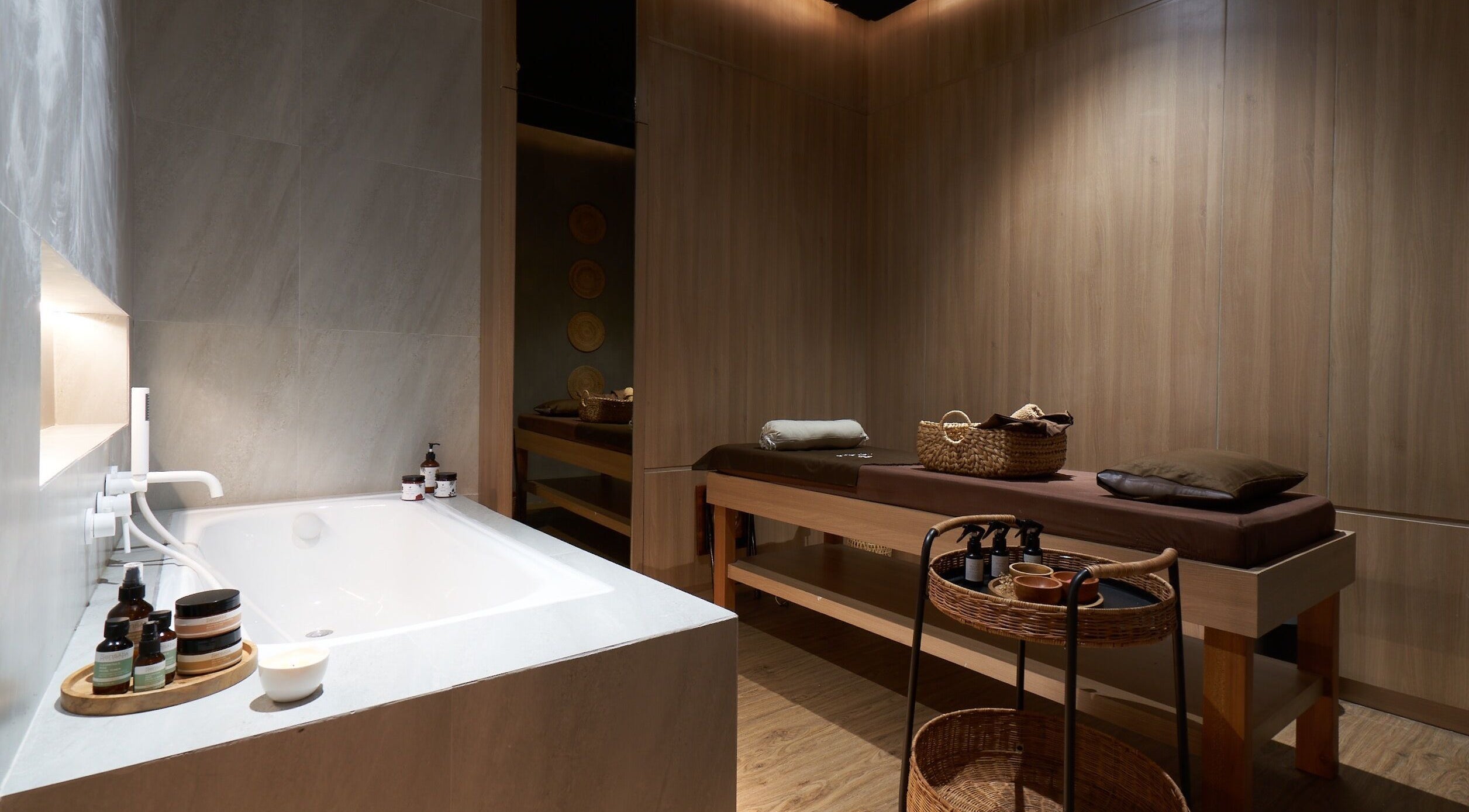 Luxurious spa room at Amansa Spa and Wellness Solo, Central Java, ID with massage bed and relaxing bath.