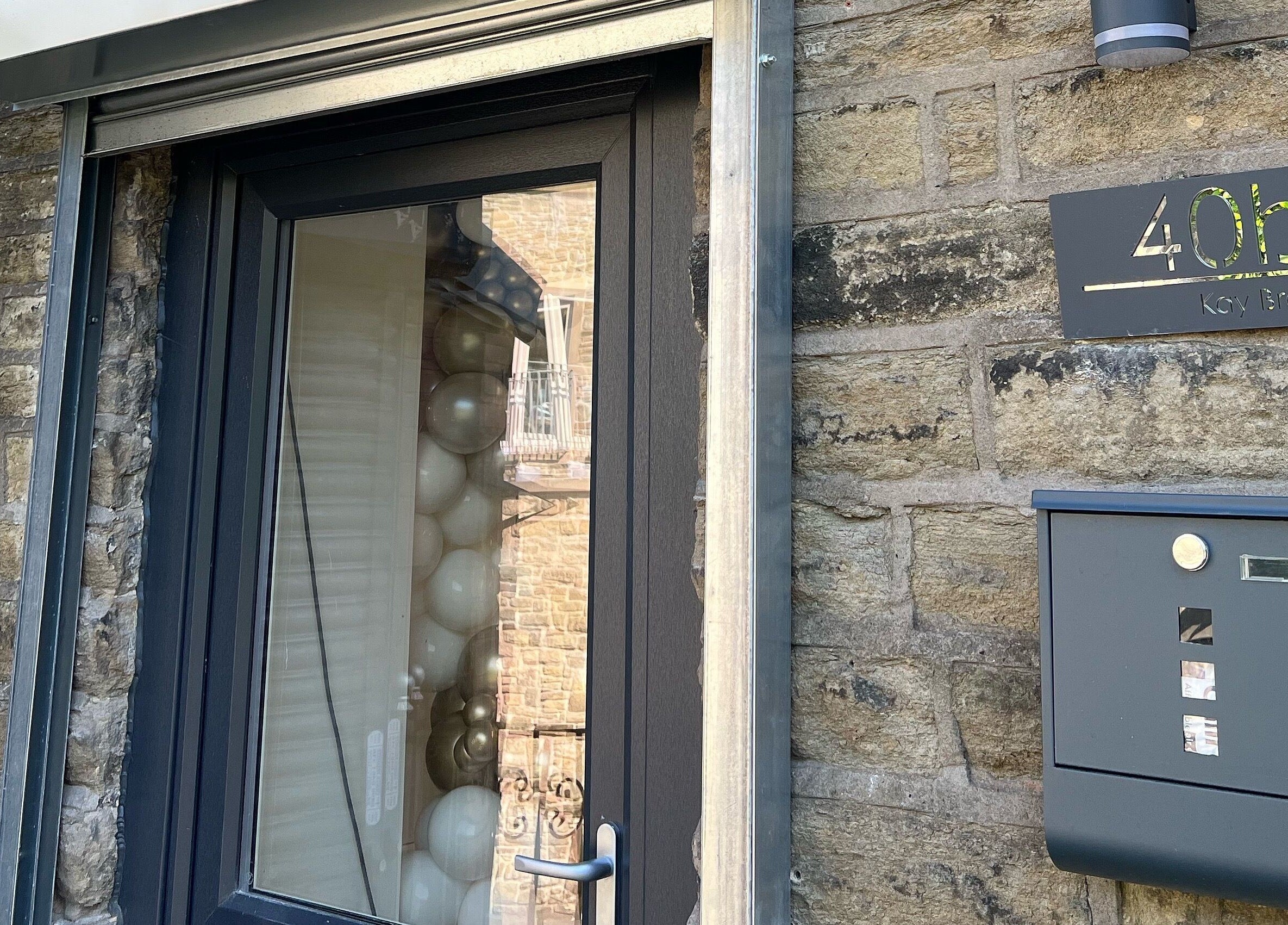 Chic entrance of Heavenly Beauty at 40b Ramsbottom, England, GB with modern window and signage.