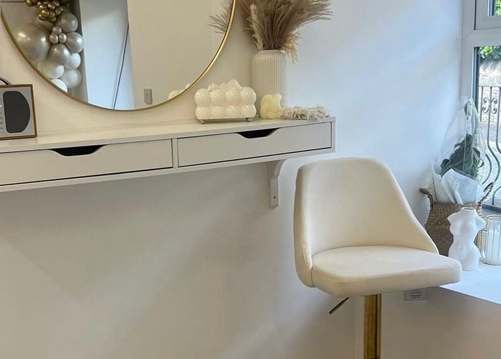 Chic beauty corner at Heavenly Beauty, Ramsbottom, England, GB, with a mirror, white chair, and decor accents.