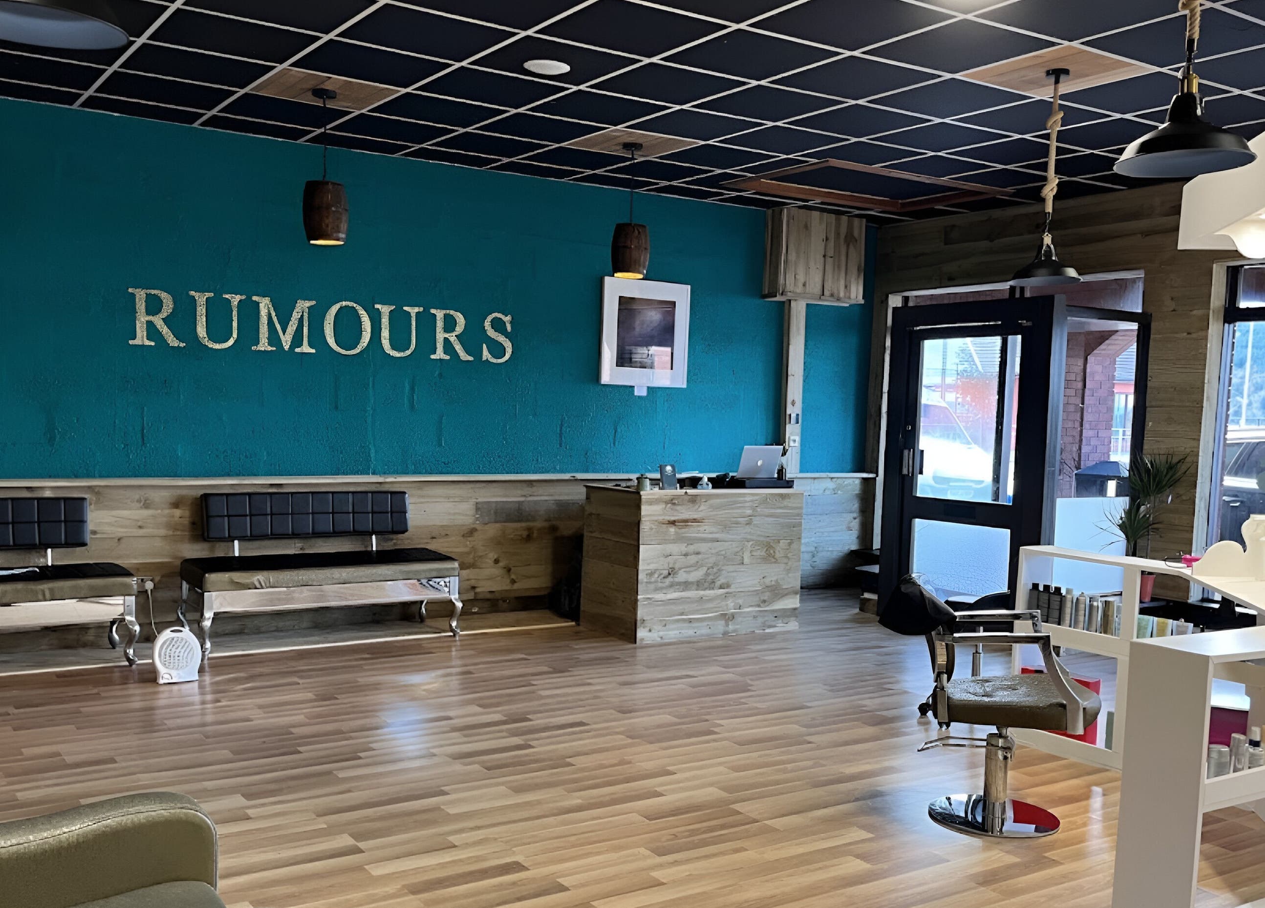 Interior of Rumours salon in Brodick, Scotland, GB showcasing chic seating and modern decor.
