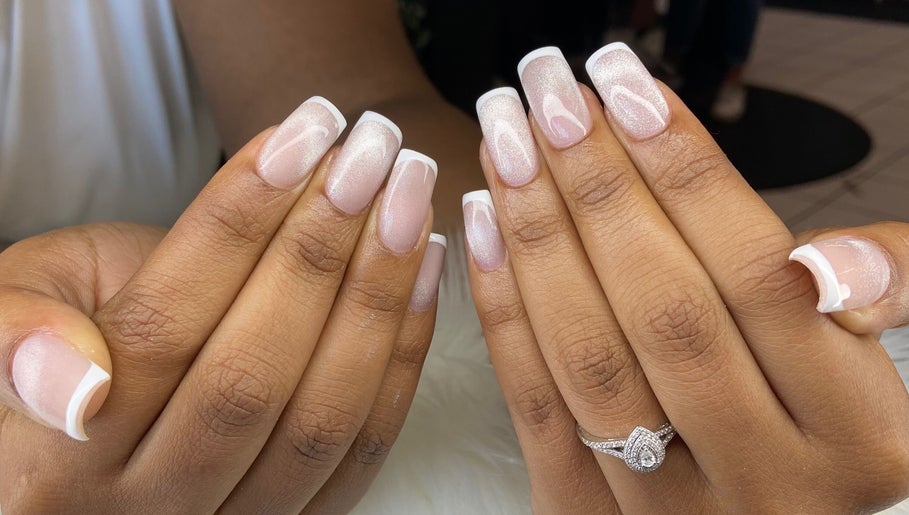 French manicure at Pretty Nails By Sasha, Rockledge, Florida. Two hands display elegant French tips.