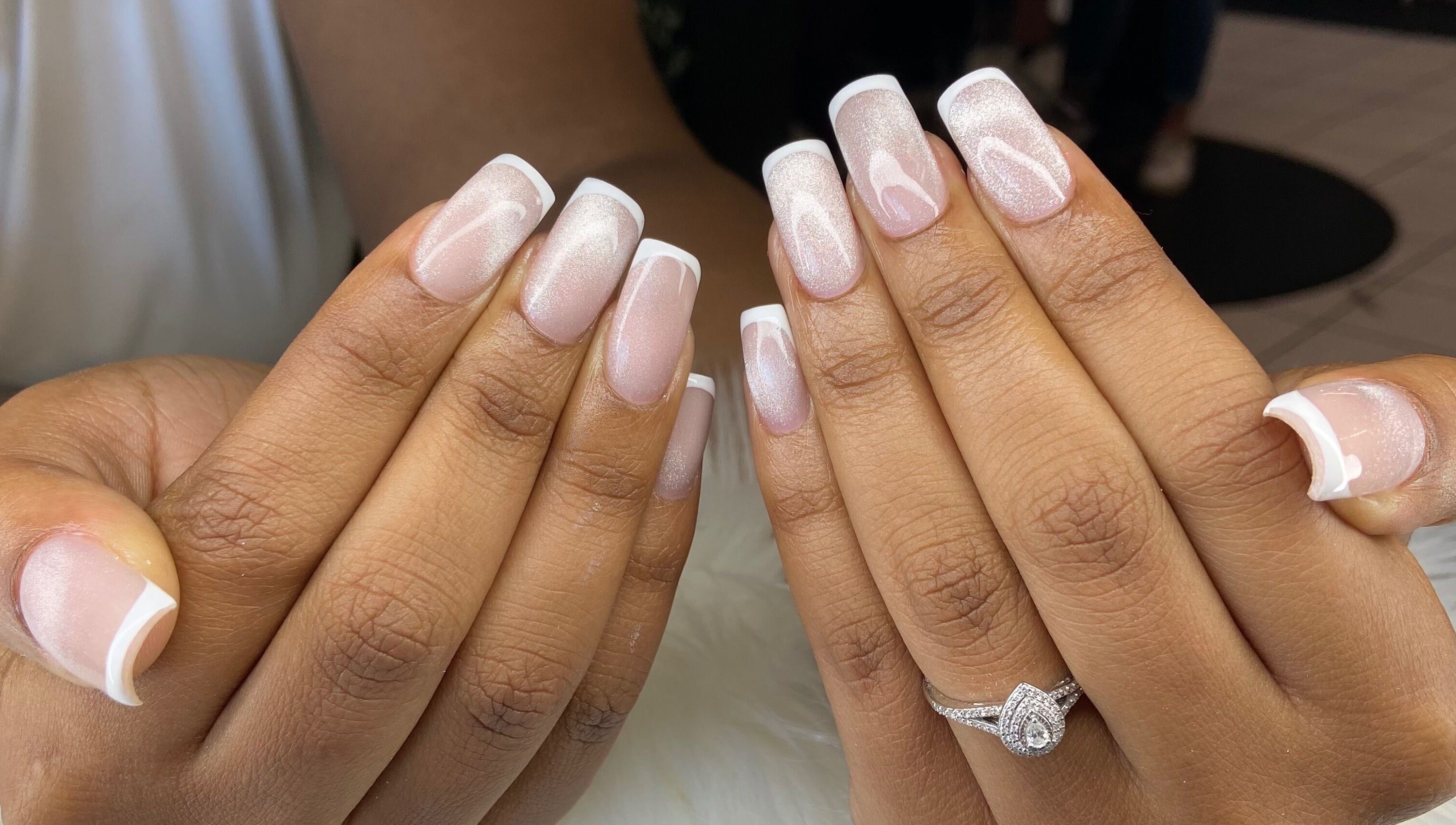 French manicure at Pretty Nails By Sasha, Rockledge, Florida. Two hands display elegant French tips.