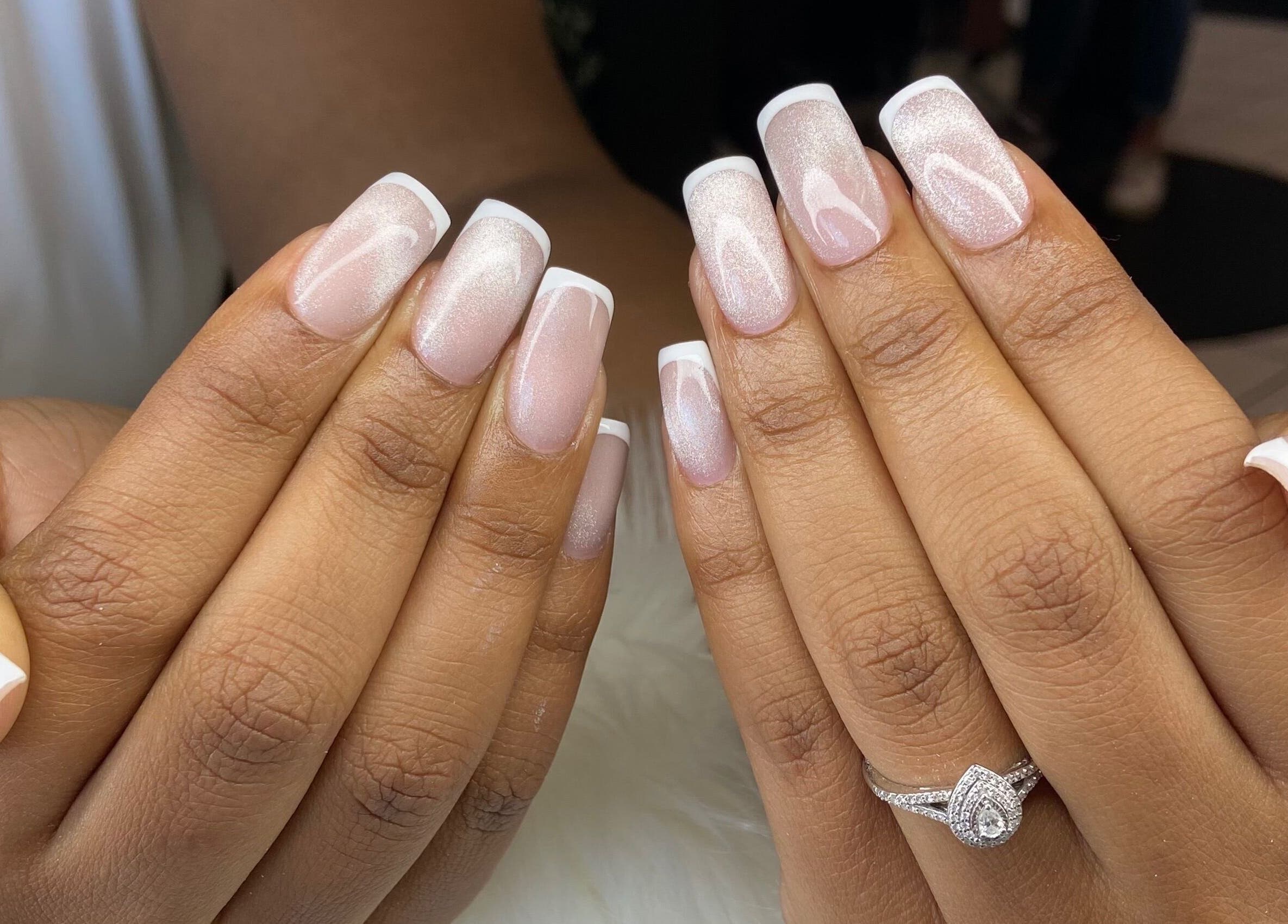 French manicure at Pretty Nails By Sasha, Rockledge, Florida. Two hands display elegant French tips.
