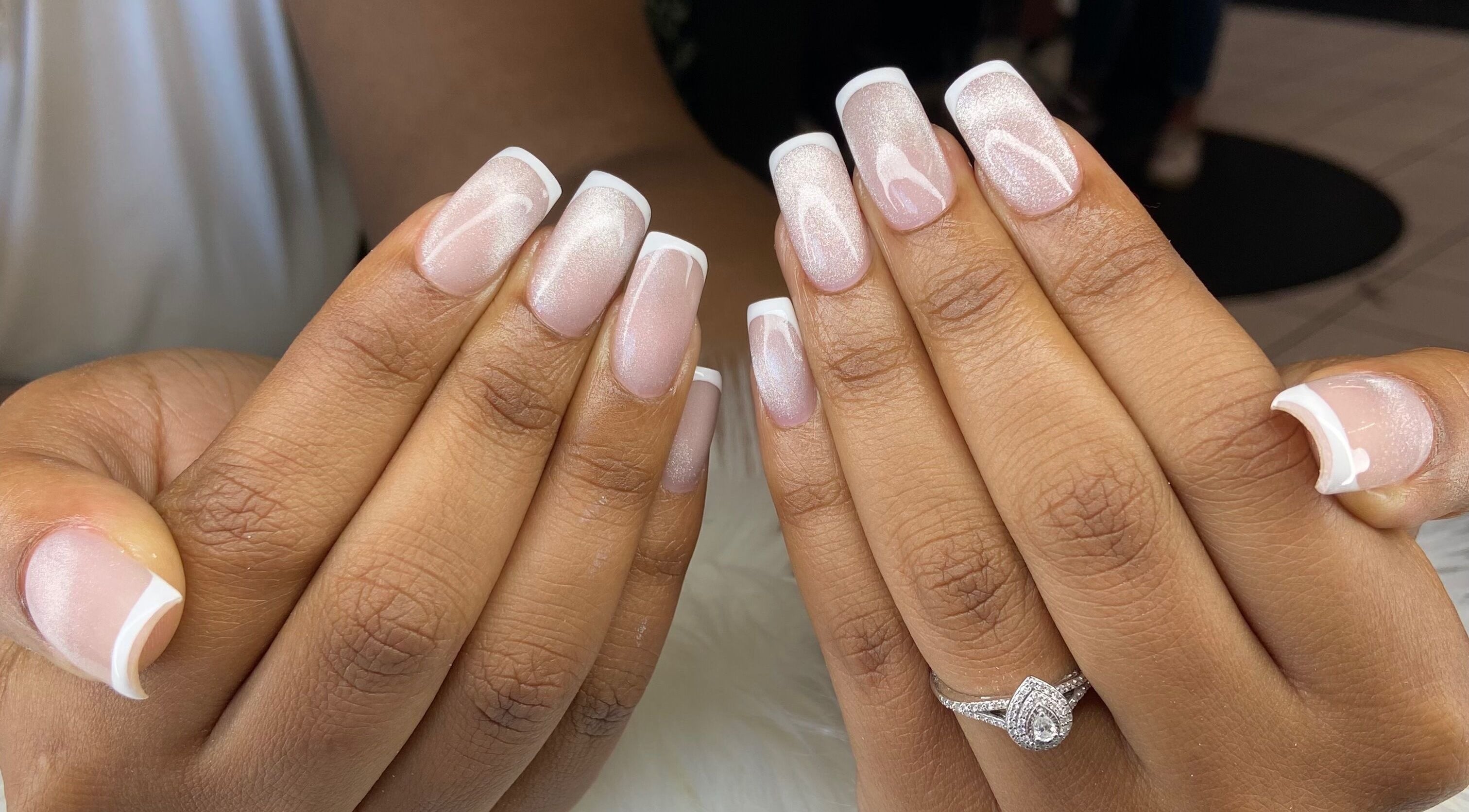 French manicure at Pretty Nails By Sasha, Rockledge, Florida. Two hands display elegant French tips.