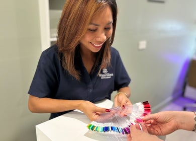 Friendly staff assisting with nail color selection at Organic Nail Care by Enji, Pelican Waters, Queensland, AU.