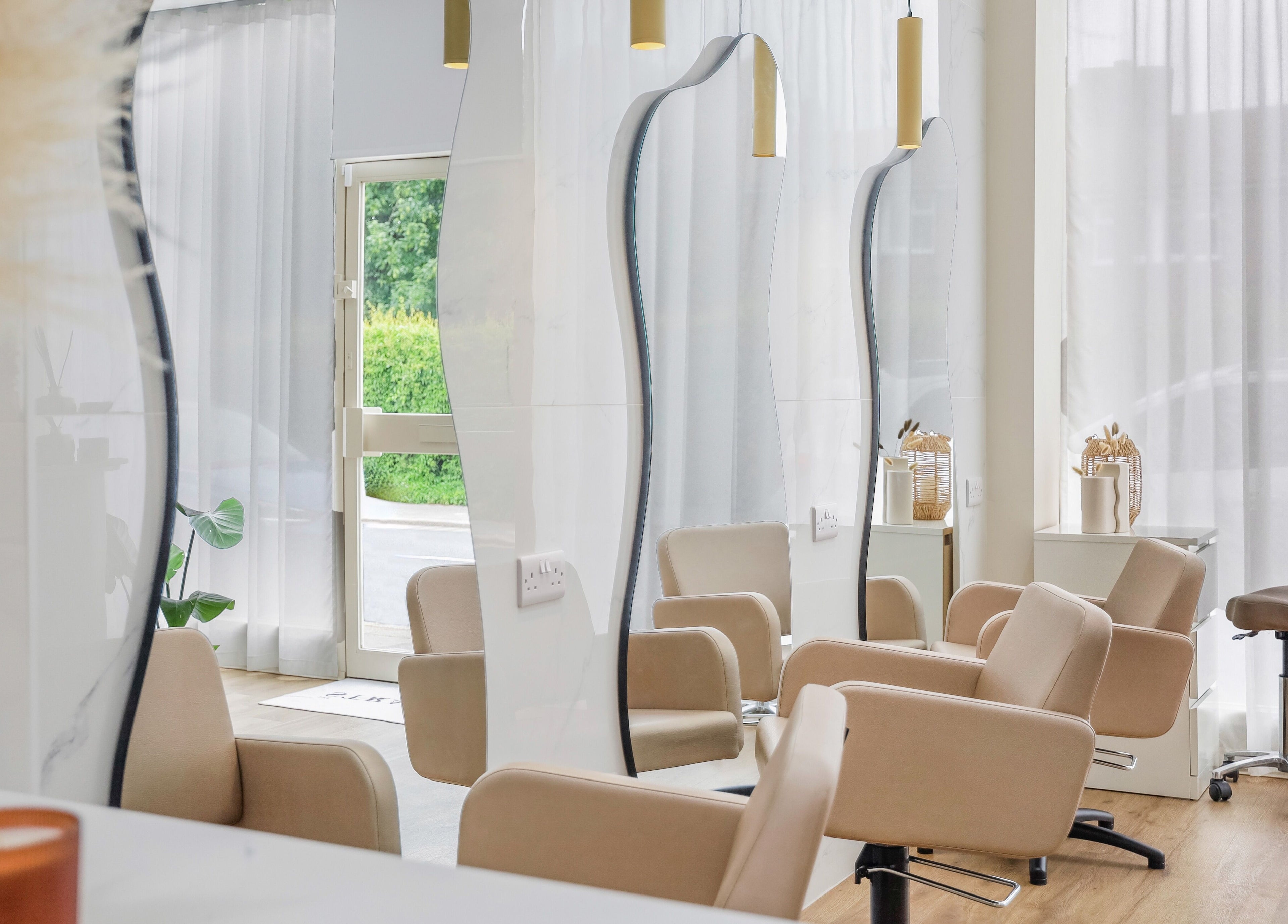 Elegant salon chairs at The Strand Designs, a stylish venue in Kenley, England, GB, offering a serene ambiance.