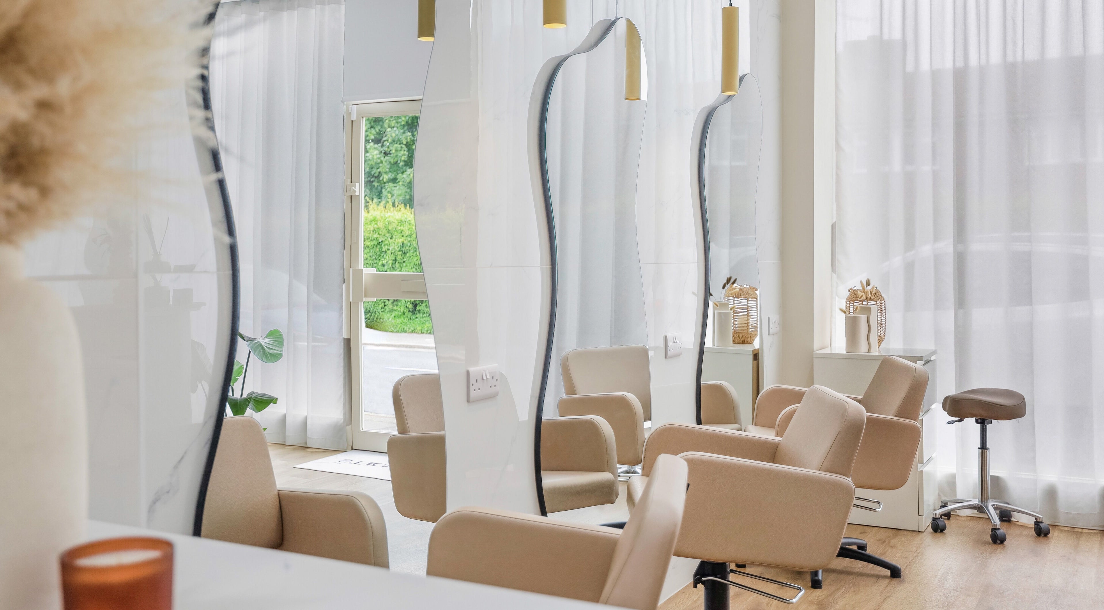 Elegant salon chairs at The Strand Designs, a stylish venue in Kenley, England, GB, offering a serene ambiance.